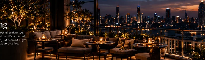 Illuminated rooftop seating with a city view